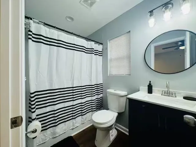 a bathroom with a sink mirror vanity and toilet