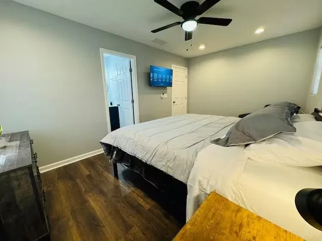 a bedroom with a bed and a window