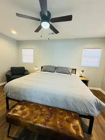 a bedroom with a bed and a chandelier