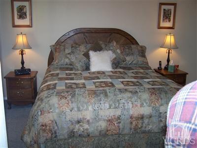 1089 Rambling Road Simi Valley, CA 93065 - Photo 14 of 25 a bedroom with a bed and a lamp