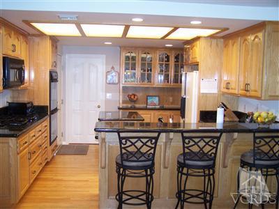 1089 Rambling Road Simi Valley, CA 93065 - Photo 3 of 25 a kitchen with stainless steel appliances a stove a sink and a refrigerator