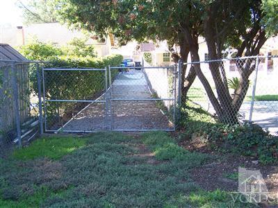 1089 Rambling Road Simi Valley, CA 93065 - Photo 22 of 25 a view of backyard with wooden fence and large trees