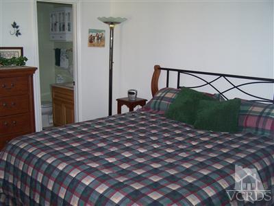 1089 Rambling Road Simi Valley, CA 93065 - Photo 5 of 25 a bedroom with a bed and a chandelier