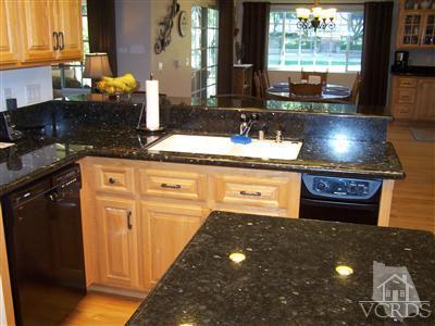 1089 Rambling Road Simi Valley, CA 93065 - Photo 6 of 25 a kitchen with stainless steel appliances a sink stove and cabinets