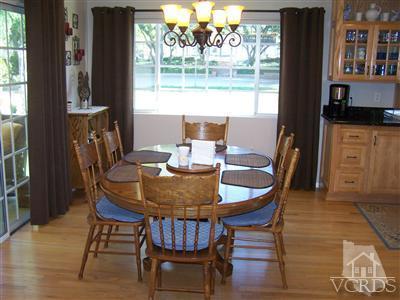 1089 Rambling Road Simi Valley, CA 93065 - Photo 7 of 25 a view of a dining room with furniture window and wooden floor