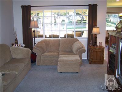 1089 Rambling Road Simi Valley, CA 93065 - Photo 8 of 25 a living room with furniture and a flat screen tv