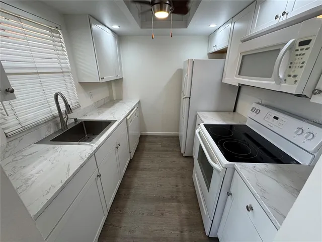a kitchen with a sink a stove and refrigerator