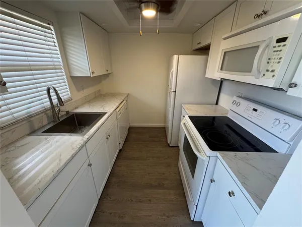 a kitchen with a sink and a stove top oven