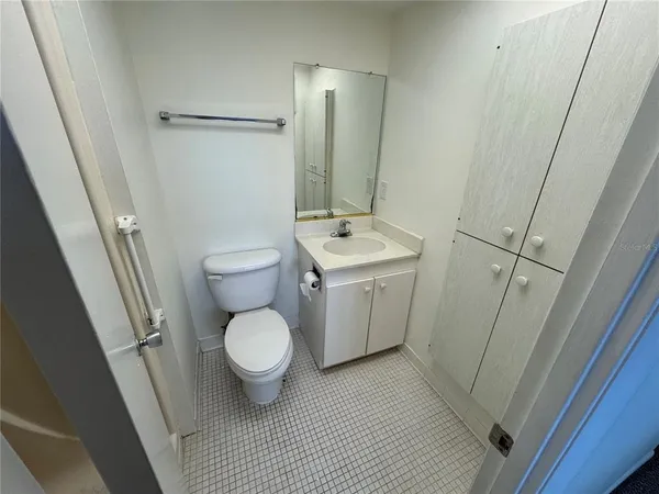 a bathroom with a toilet sink and a mirror