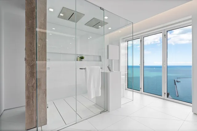 a living room with furniture and floor to ceiling windows