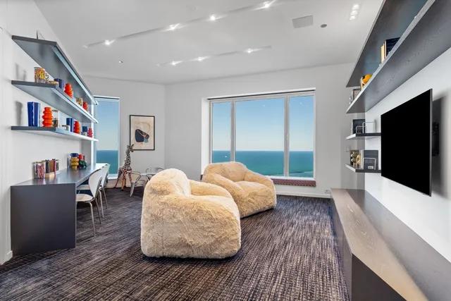 a bedroom with a bed a couch and dresser