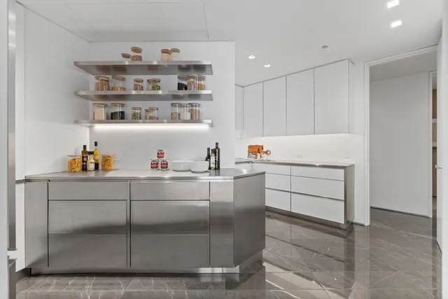 a living room with patio furniture and a fireplace