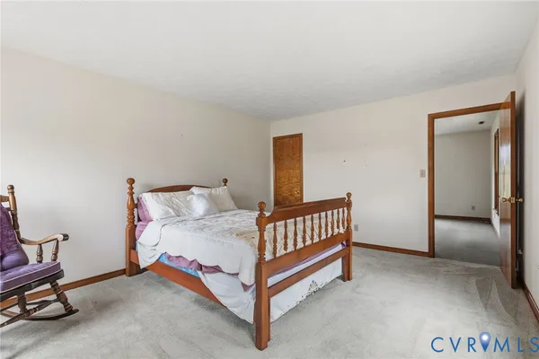 a bedroom with a bed and chair