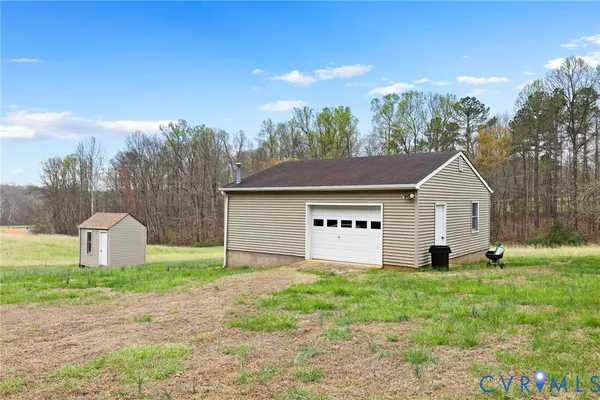 a house with green field in front of it