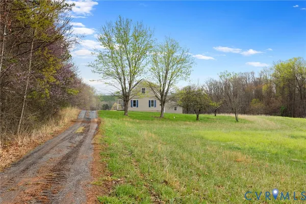 a view of a house with yard and tree s