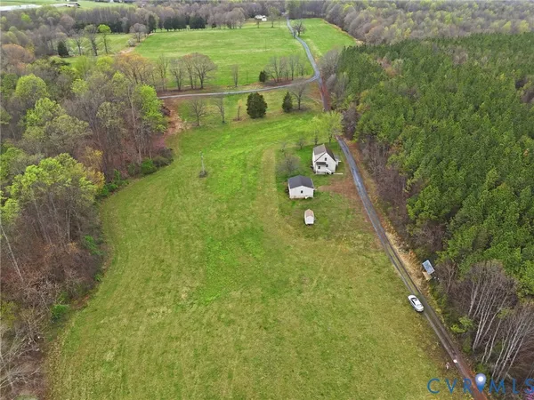 a view of a big yard with large trees