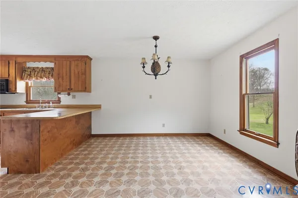 a large kitchen with lot of cabinets and window