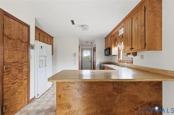 a view of a kitchen with a stove and cabinets