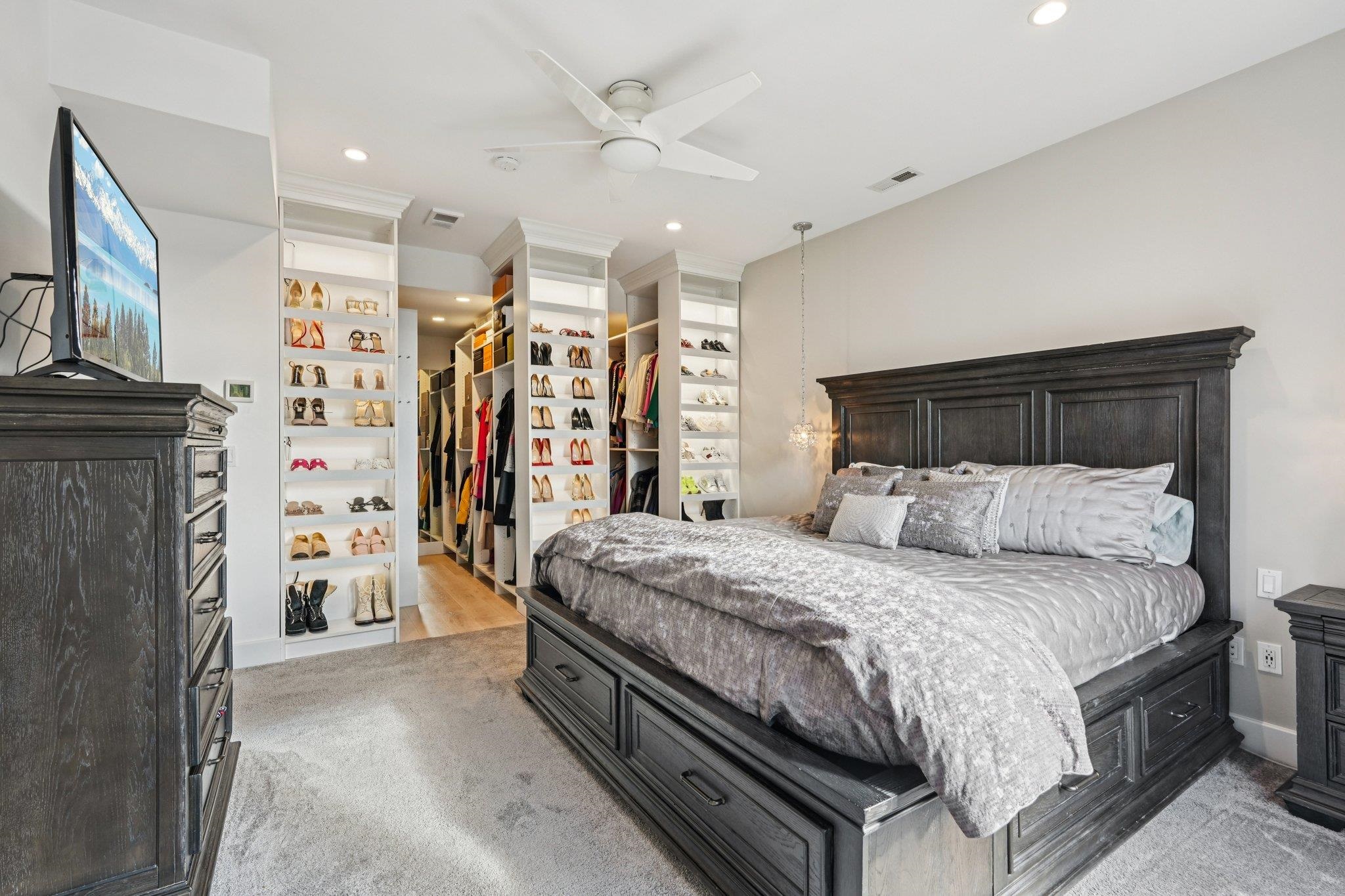 25 Vela Way, Unit 25 Edgewater, NJ 07020 - Photo 24 of 42 a bedroom with a large bed a flat tv screen and dresser