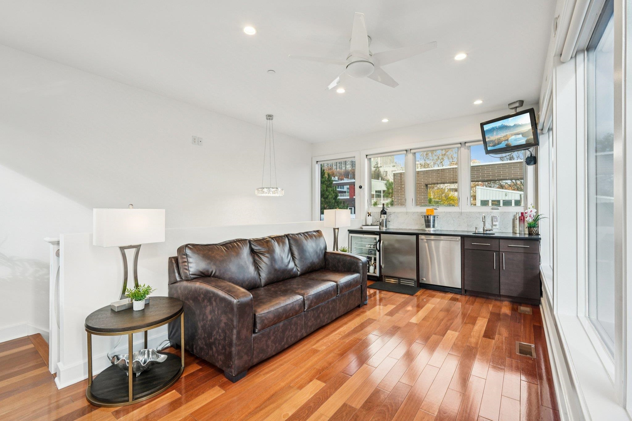 25 Vela Way, Unit 25 Edgewater, NJ 07020 - Photo 4 of 42 a living room with kitchen island furniture and a wooden floor