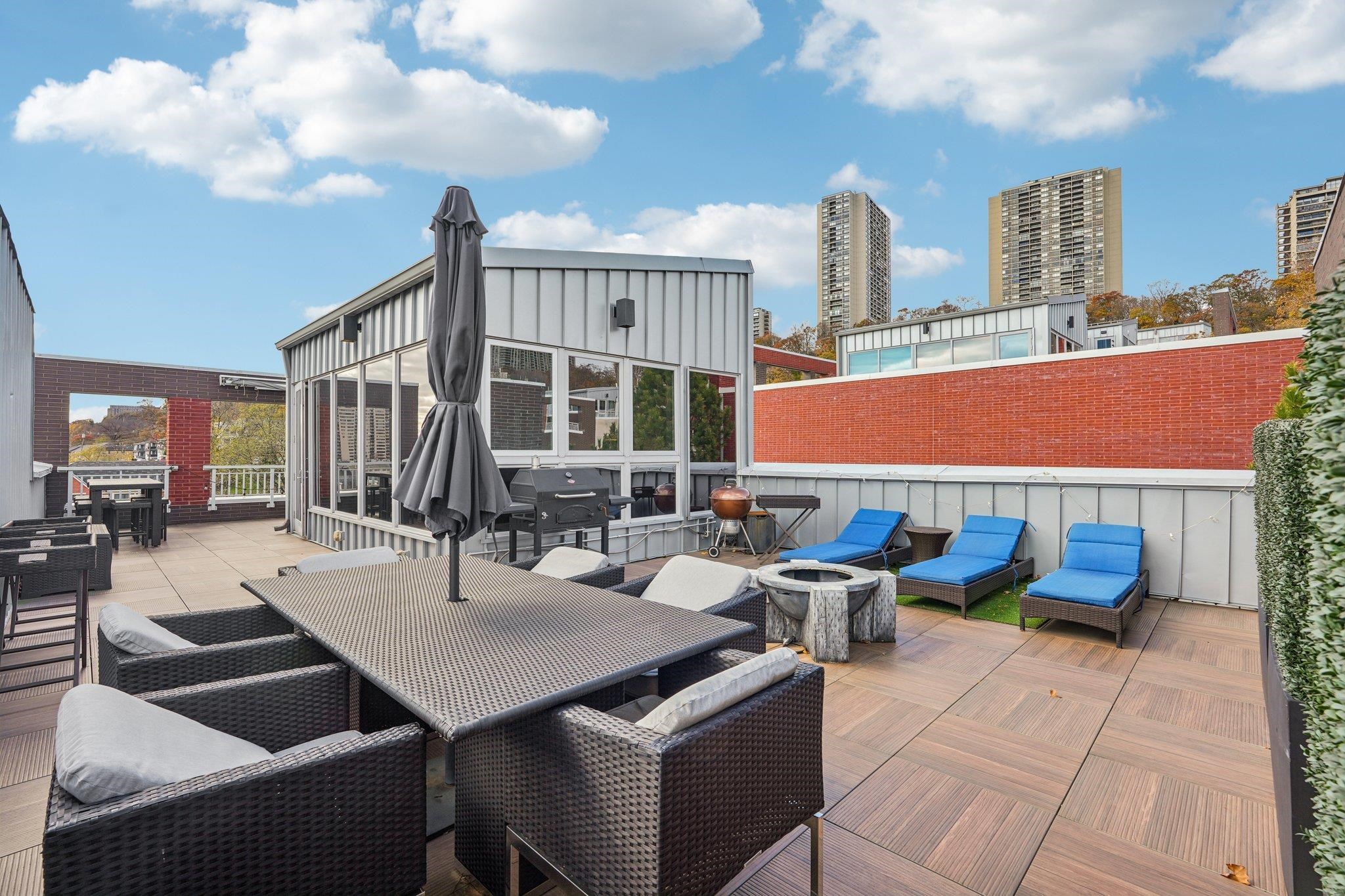 25 Vela Way, Unit 25 Edgewater, NJ 07020 - Photo 6 of 42 a outdoor space with lots of tables a computer and a couch