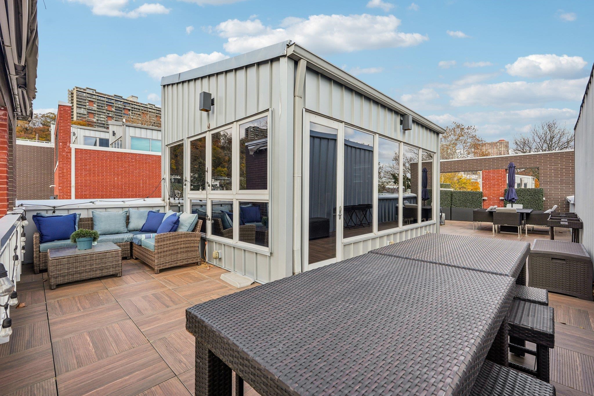 25 Vela Way, Unit 25 Edgewater, NJ 07020 - Photo 7 of 42 a view of living room kitchen with patio and outdoor seating