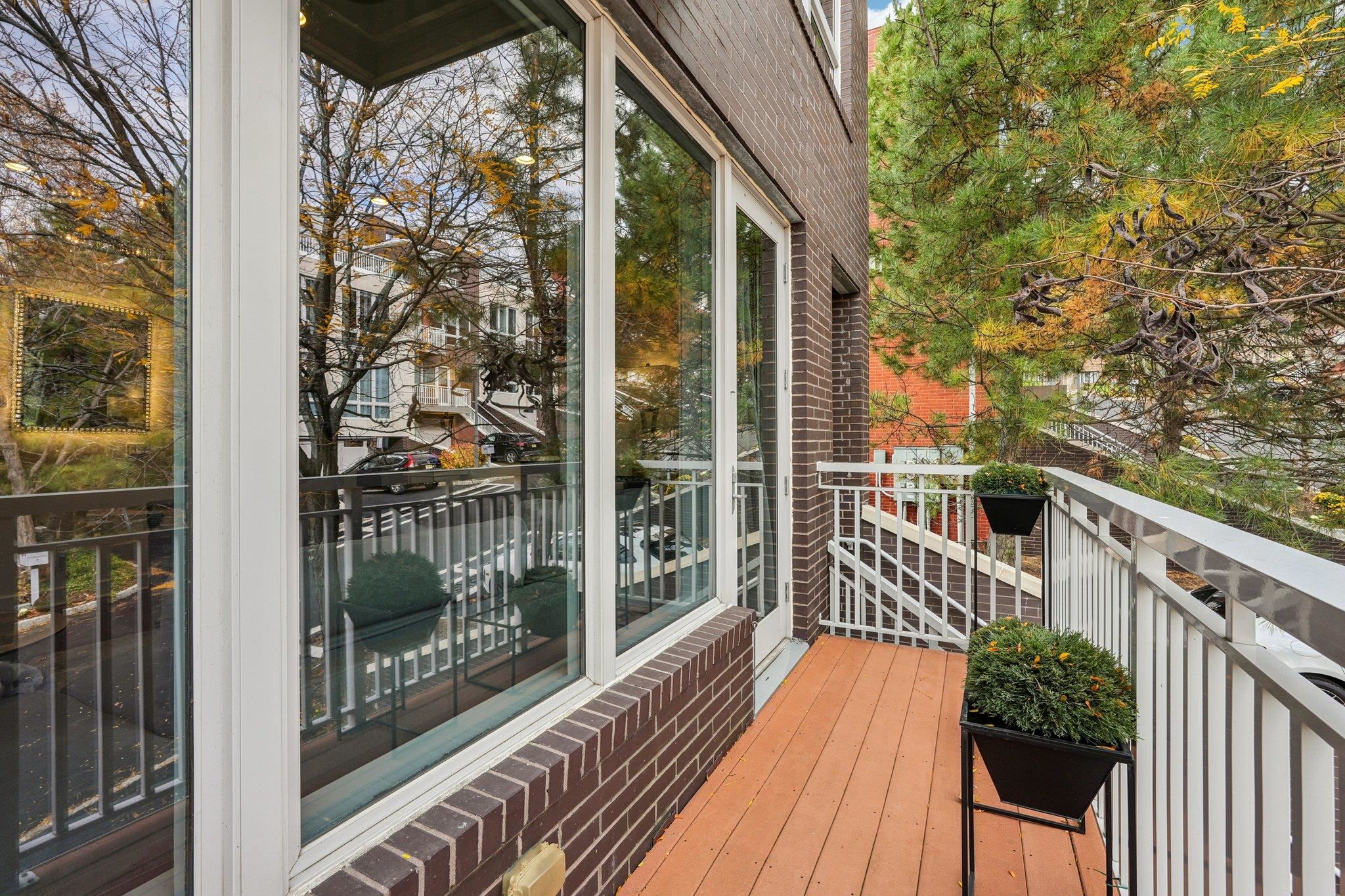 25 Vela Way, Unit 25 Edgewater, NJ 07020 - Photo 8 of 42 a balcony with wooden floor