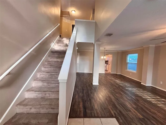 a view of entryway and hall with wooden floor