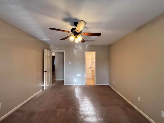 a view of a livingroom with a ceiling fan and window
