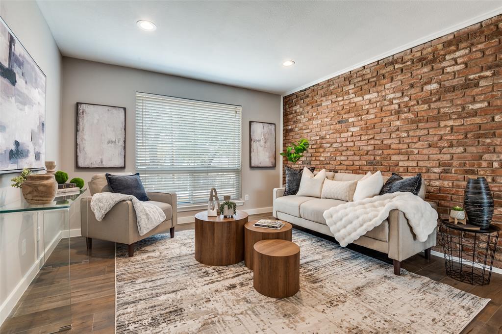 a living room with furniture a rug and a window