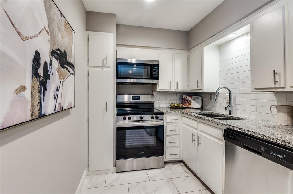 4340 Cedar Springs Road, Unit 205 Dallas, TX 75219 - Photo 5 of 12 a kitchen with stainless steel appliances granite countertop a stove and a sink