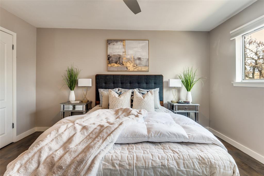 4340 Cedar Springs Road, Unit 205 Dallas, TX 75219 - Photo 8 of 12 a bedroom with a large bed and a potted plant