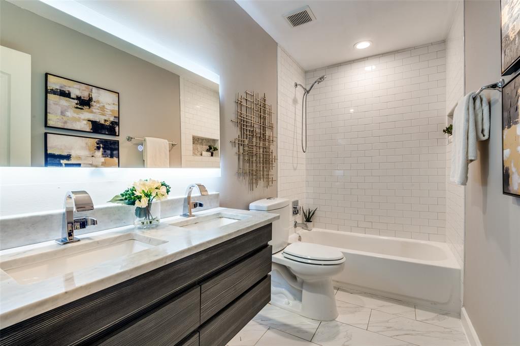 4340 Cedar Springs Road, Unit 205 Dallas, TX 75219 - Photo 9 of 12 a bathroom with a double vanity sink toilet and shower