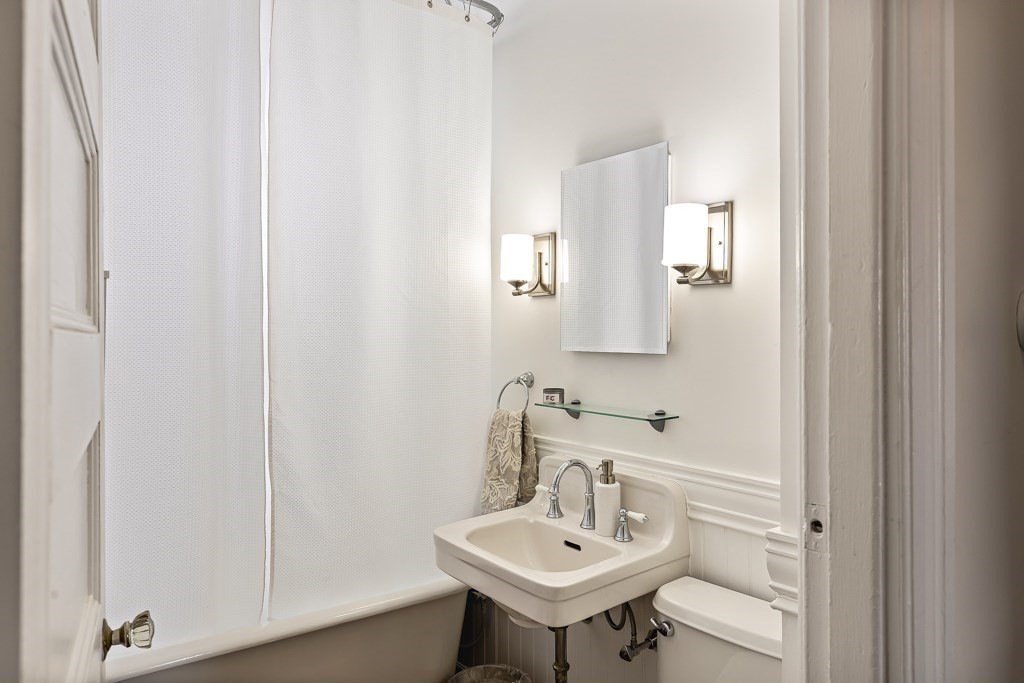 55 Main Street Somerville, MA 02145 - Photo 16 of 28 a bathroom with a sink and a mirror
