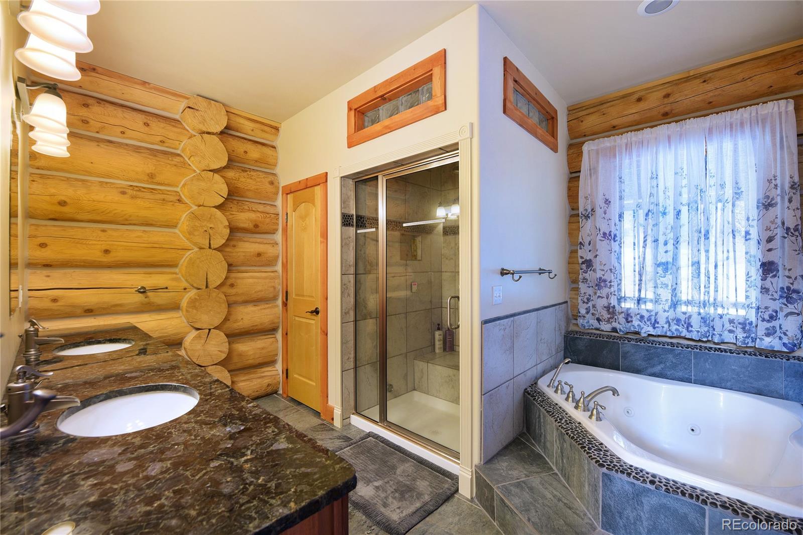500 Ridge Road Ward, CO 80481 - Photo 14 of 31 a bathroom with a tub a sink and a shower