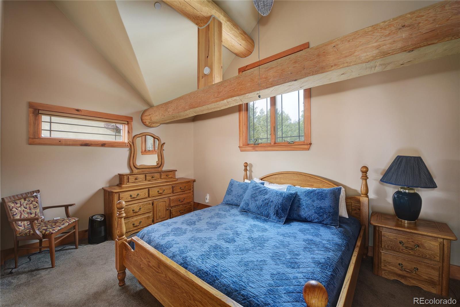 500 Ridge Road Ward, CO 80481 - Photo 16 of 31 a bedroom with a bed and dresser with mirror