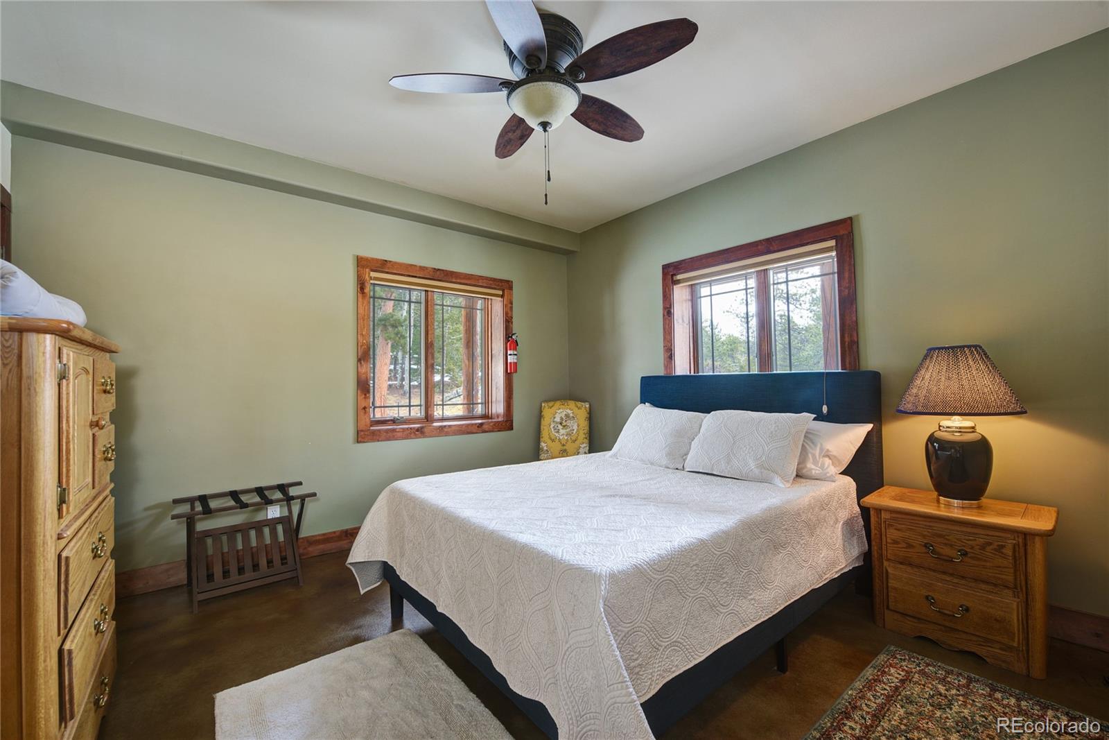 500 Ridge Road Ward, CO 80481 - Photo 19 of 31 a bedroom with a bed and a chandelier