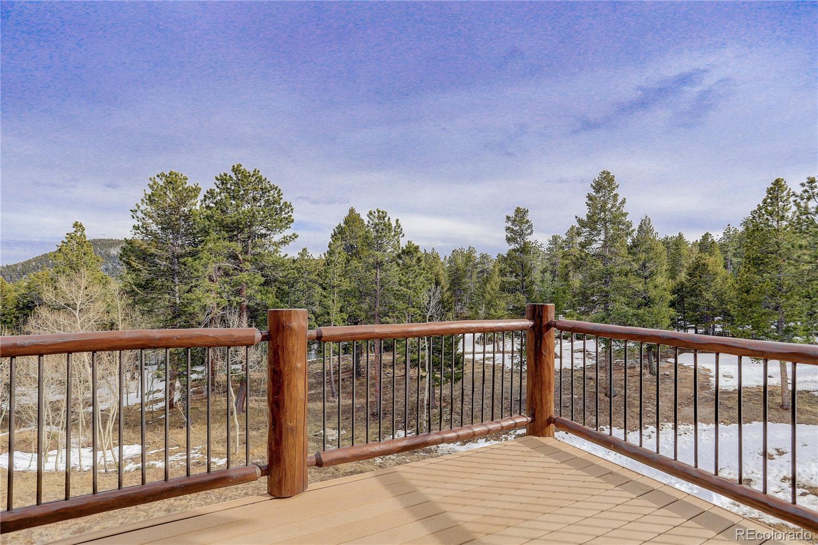 500 Ridge Road Ward, CO 80481 - Photo 26 of 31 a balcony with wooden floor and fence
