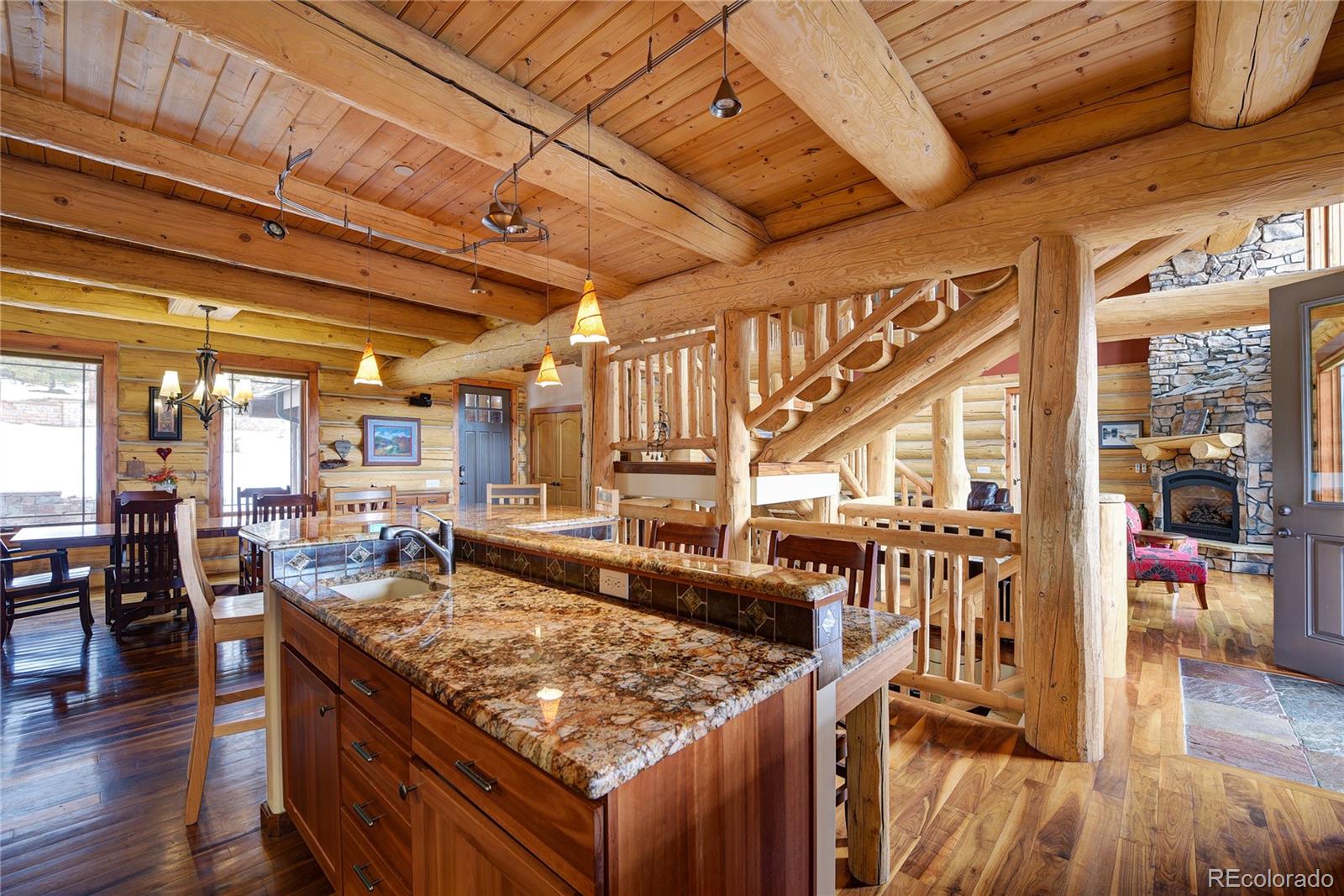 500 Ridge Road Ward, CO 80481 - Photo 7 of 31 a kitchen with stainless steel appliances granite countertop a stove a sink and a wooden cabinets