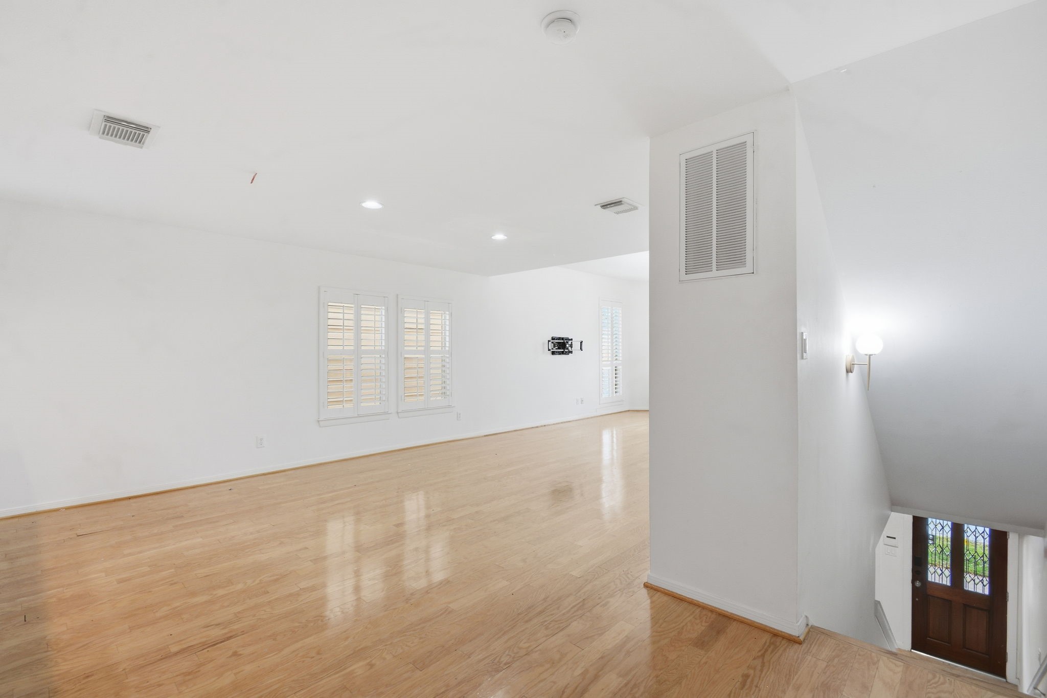 1714 West Webster Street Houston, TX 77019 - Photo 13 of 39 a view of an empty room with wooden floor and a window