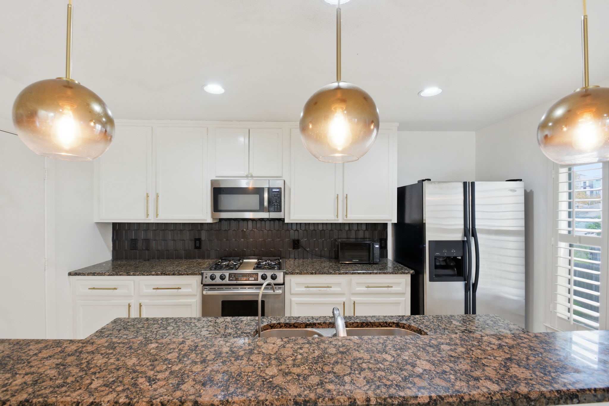 1714 West Webster Street Houston, TX 77019 - Photo 21 of 39 a kitchen with stainless steel appliances kitchen island granite countertop a stove and a sink