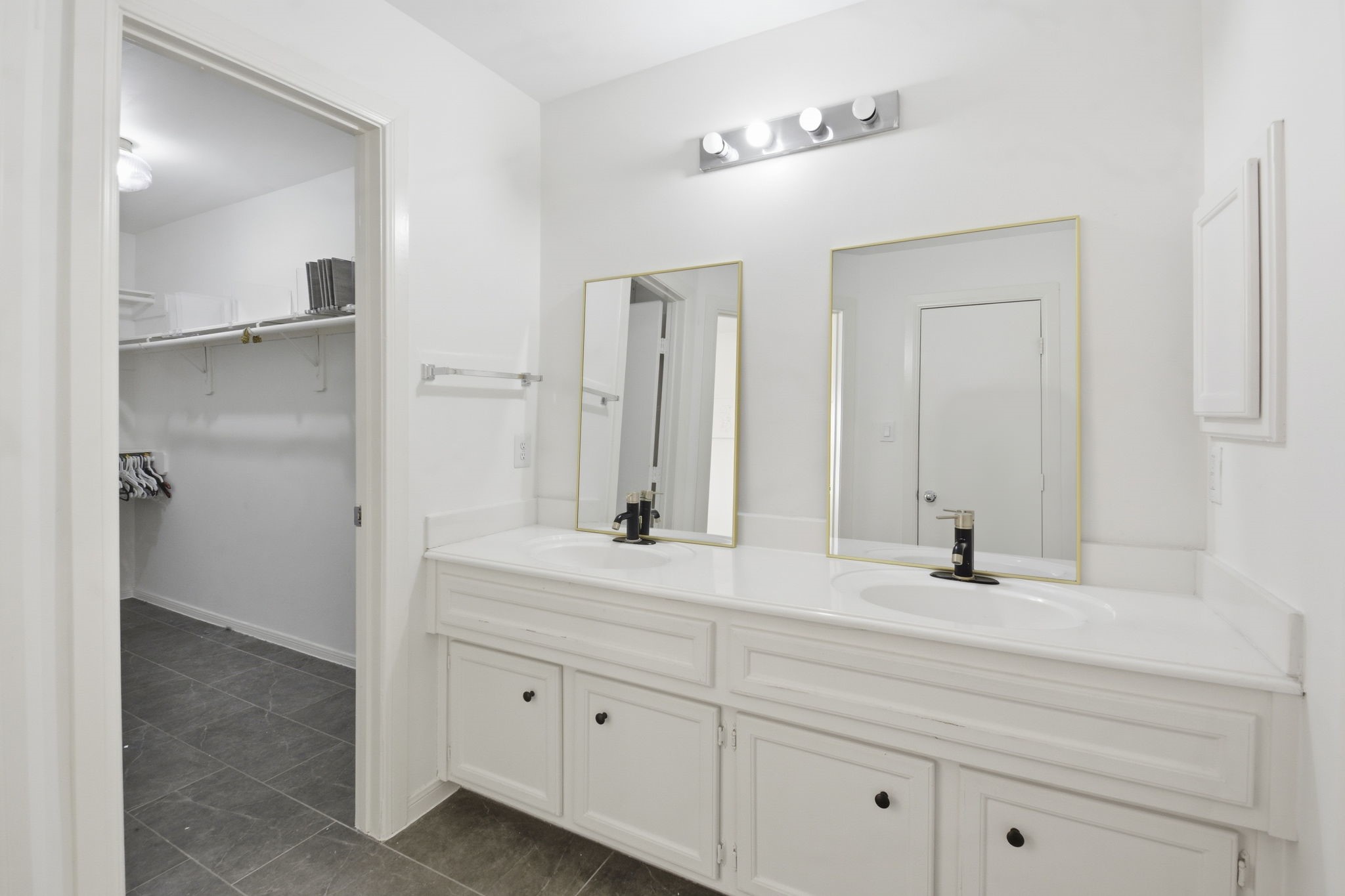 1714 West Webster Street Houston, TX 77019 - Photo 31 of 39 a bathroom with a double vanity sink and mirror