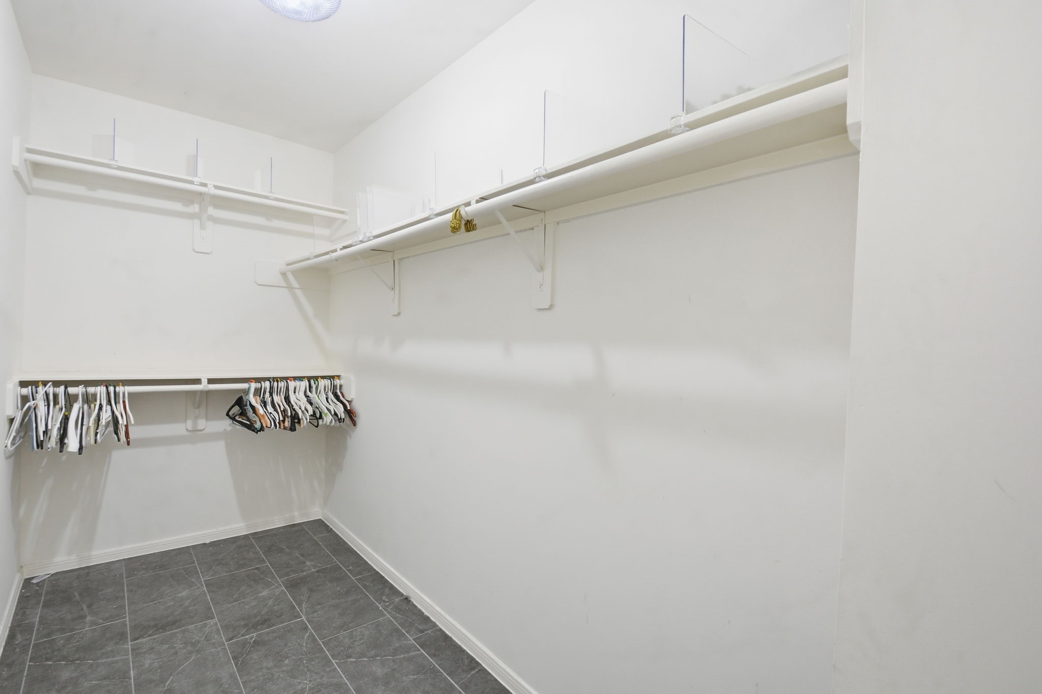 1714 West Webster Street Houston, TX 77019 - Photo 34 of 39 a view of walk in closet with empty racks