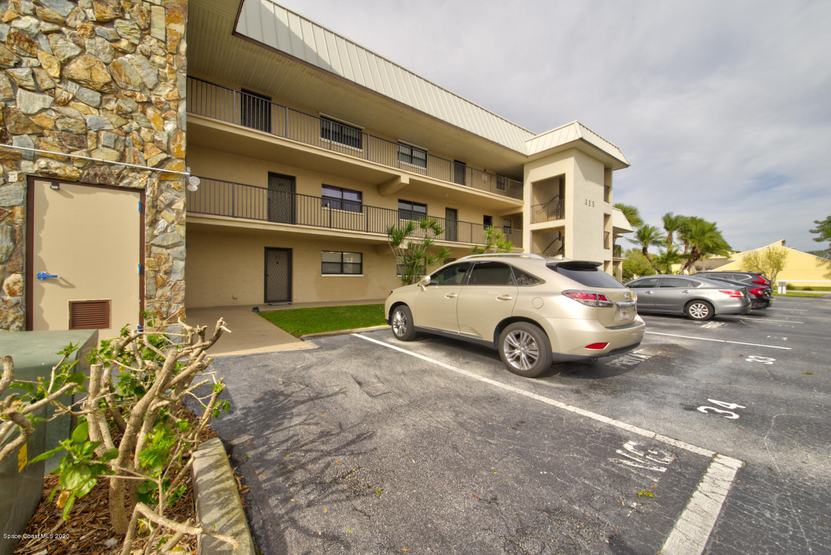 325 Tangle Run Boulevard, Unit 1125 Melbourne, FL 32940 - Photo 1 of 22 a view of a car parked in front of a building