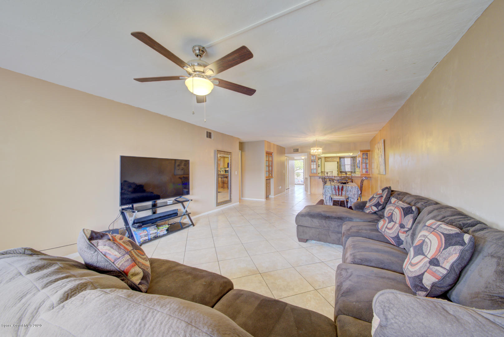 325 Tangle Run Boulevard, Unit 1125 Melbourne, FL 32940 - Photo 12 of 22 a living room with furniture and a flat screen tv