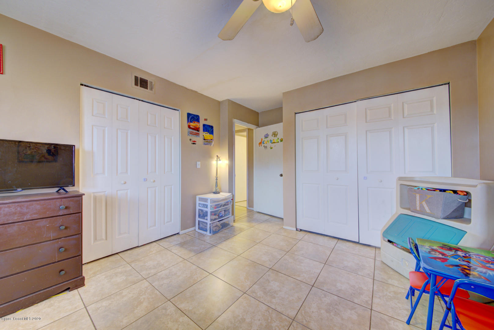 325 Tangle Run Boulevard, Unit 1125 Melbourne, FL 32940 - Photo 16 of 22 a living room with furniture and a flat screen tv