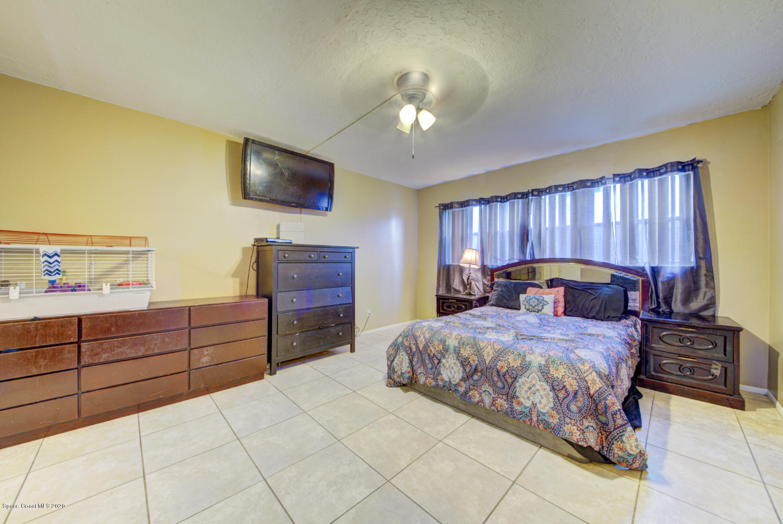 325 Tangle Run Boulevard, Unit 1125 Melbourne, FL 32940 - Photo 20 of 22 a bedroom with a bed and a flat screen tv