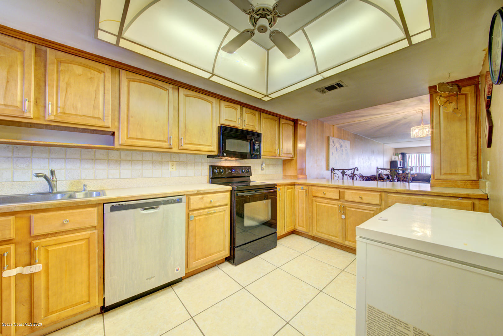 325 Tangle Run Boulevard, Unit 1125 Melbourne, FL 32940 - Photo 7 of 22 a kitchen with granite countertop a sink stainless steel appliances and cabinets