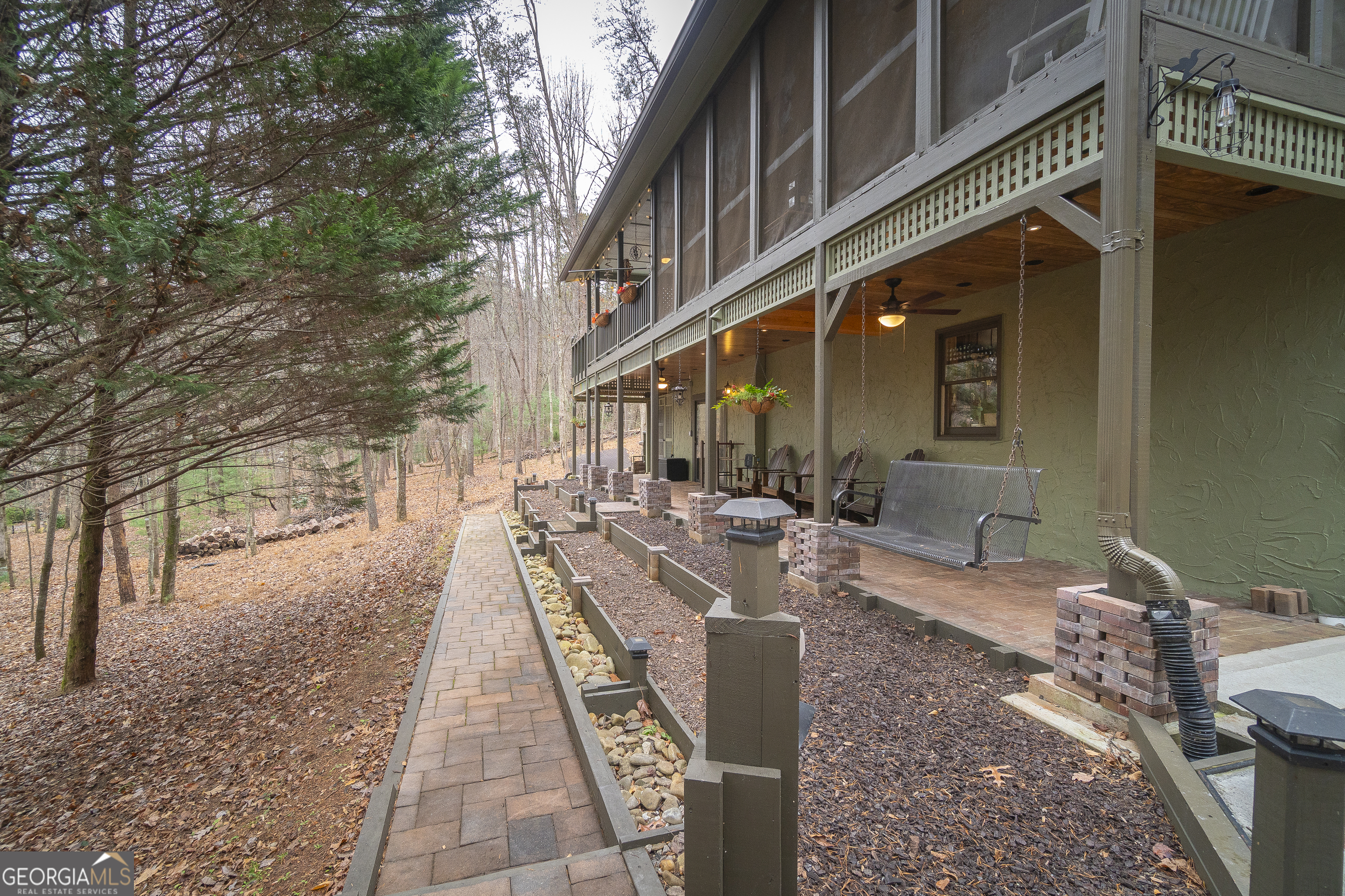 168 Cherokee Trail Sautee Nacoochee, GA 30571 - Photo 6 of 80 a view of a patio with couches table and chairs with wooden floor and fence