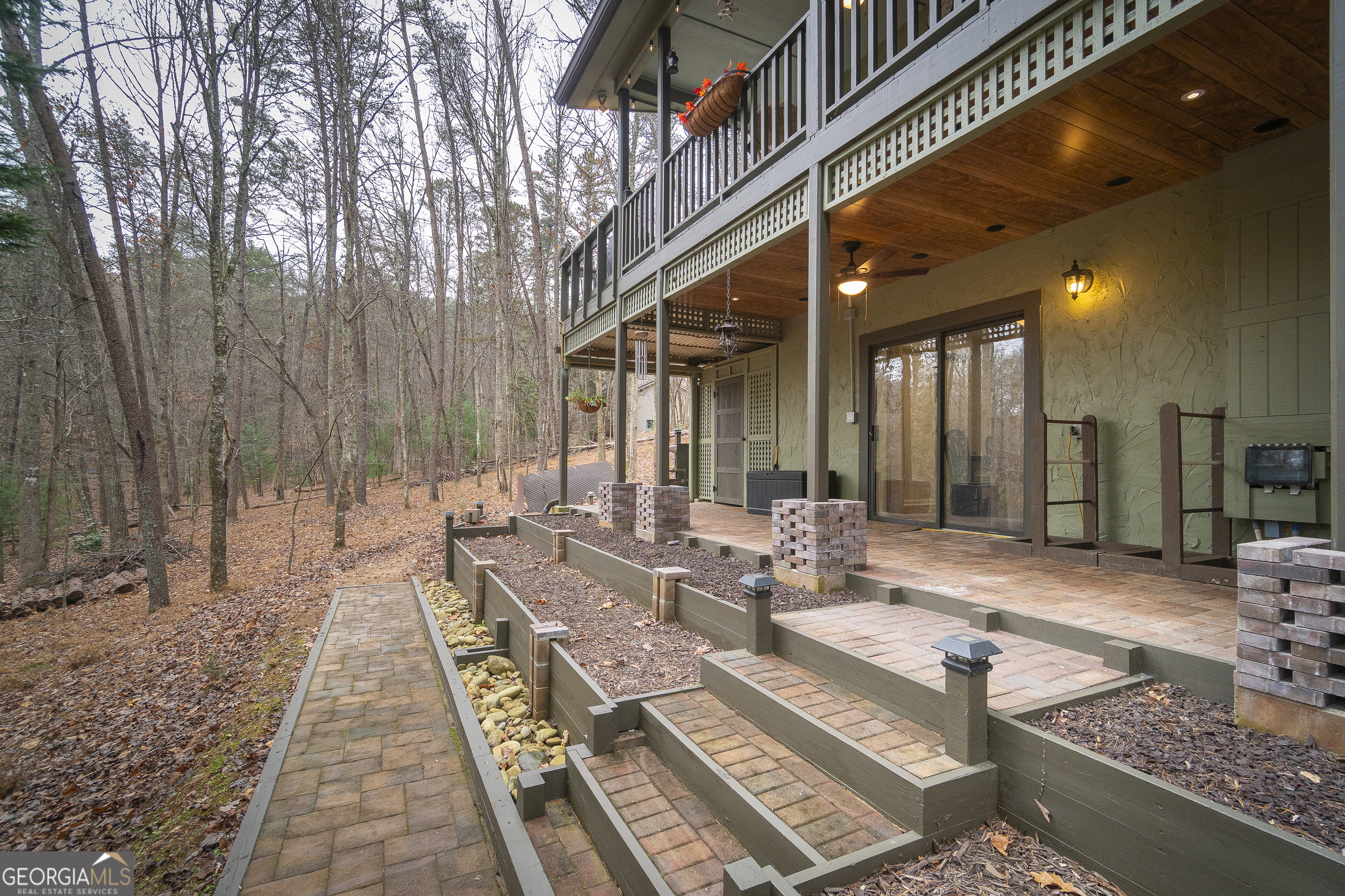 168 Cherokee Trail Sautee Nacoochee, GA 30571 - Photo 8 of 80 a view of a patio with couches table and chairs and potted plants